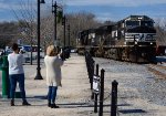 Two ladies from out of town take pictures of NS yard job E19 returning lite to Montview Yard